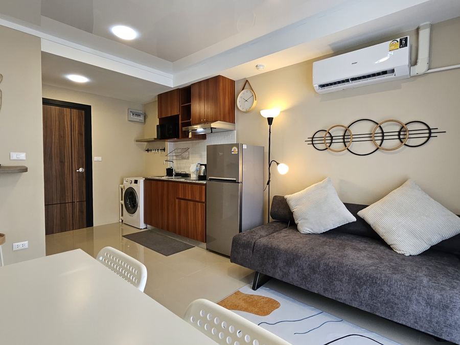 777 Beach Condo: living area with sofa and kitchen